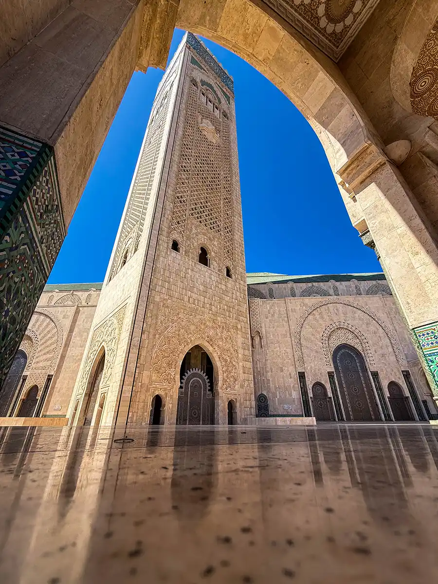 Hassan II Mosque minaret reflected in the tile floor