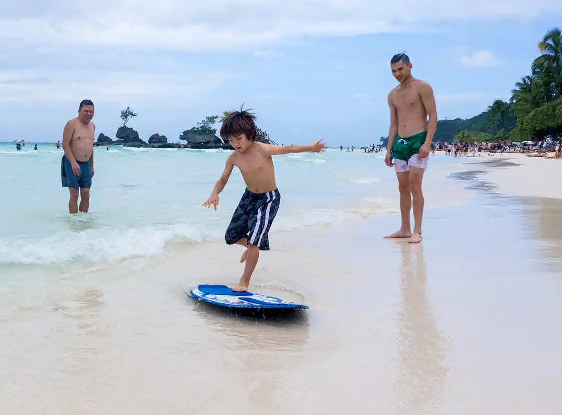 Cohen Wagar using a skimboard on White Beach Boracay