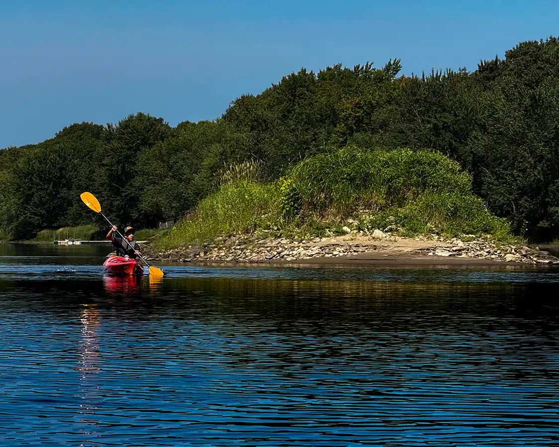 Dylan Wagar paddles past a former logjam near Fredericton