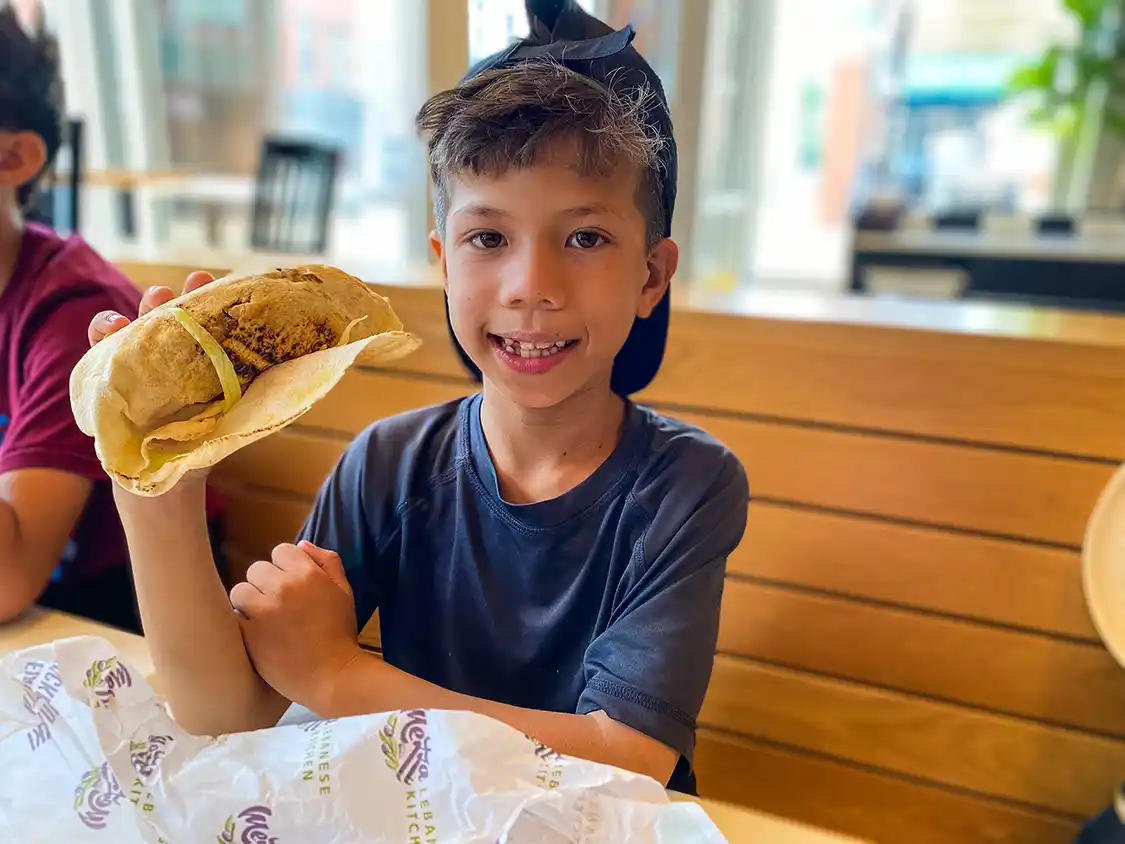 Young boy eats a donair at Mezza in Halifax