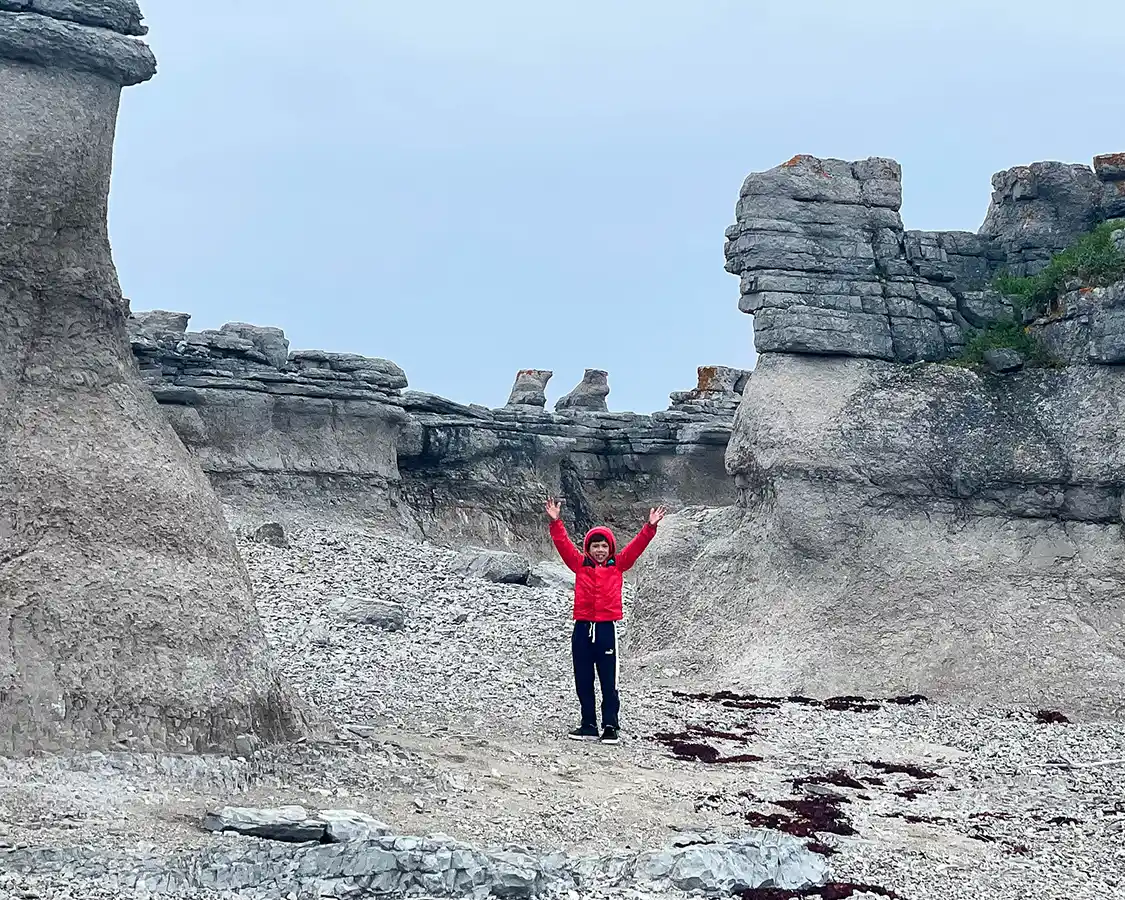 Young boy hiking through Grande Ile in the Mingan Archipelago