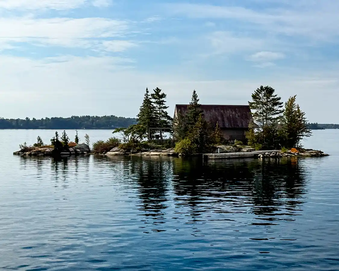 An island just big enough for a cottage and a tree in the Thousand Islands Ontario