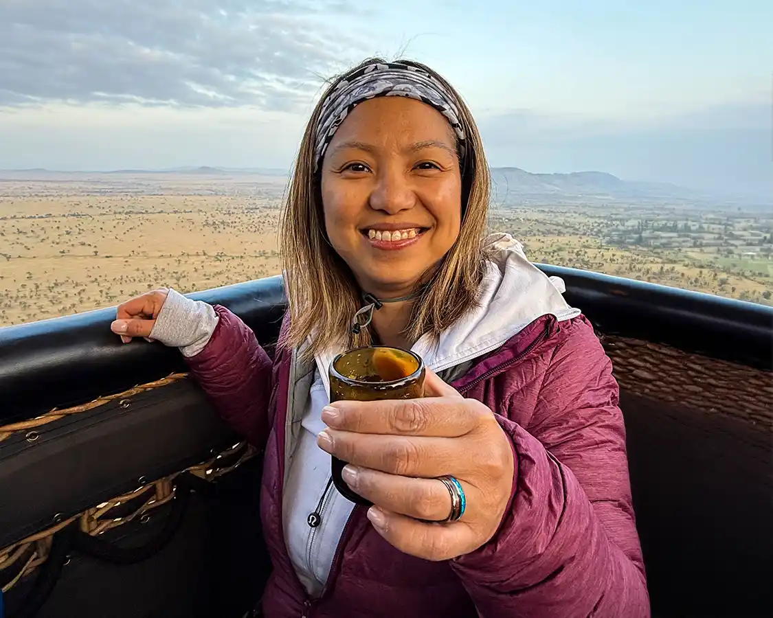 Christina Wagar having coffee in a hot air balloon over the Serengeti